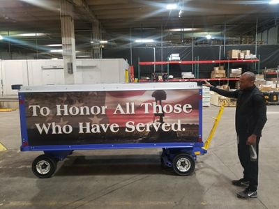 Andre Sims, Cargo Customer Service Manager, stands next to the decorated MHR cart in Atlanta