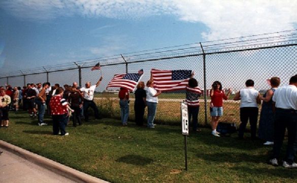 Employees line the fence at Southwest Headquarters to watch the first flight take off from Dallas Love Field (DAL) after the 9/11 terrorist attacks