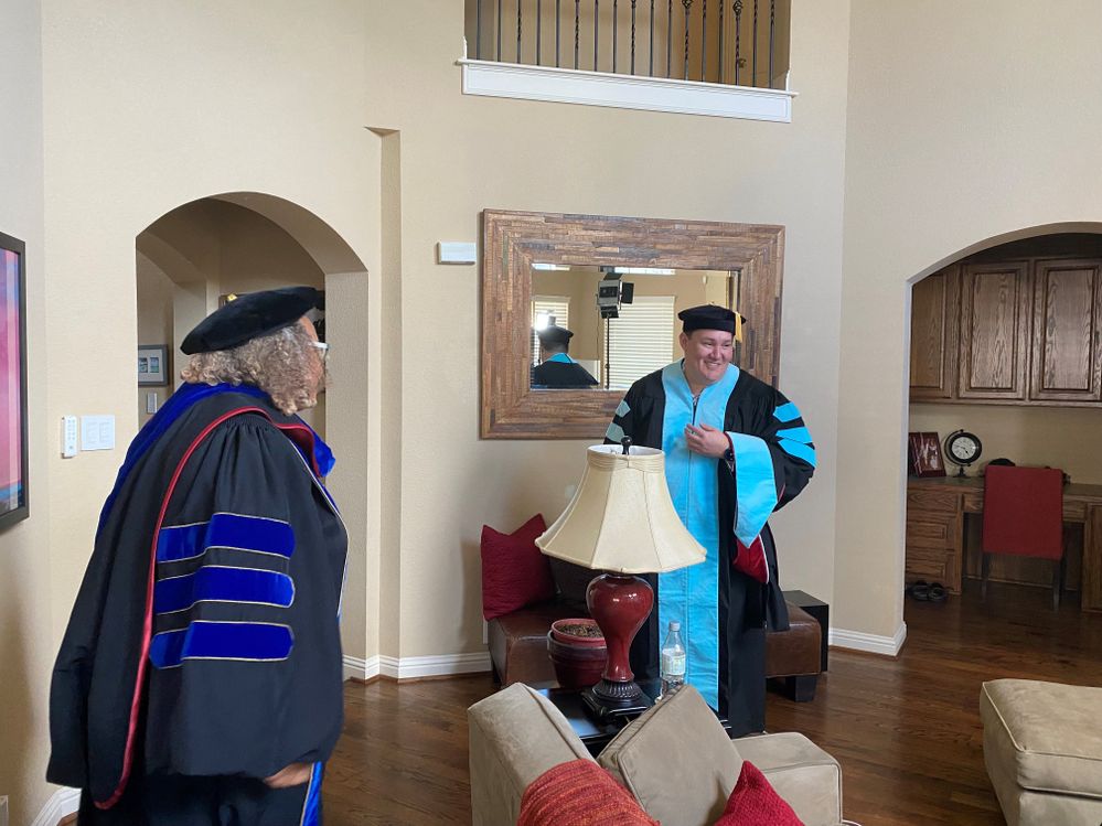 Victor preparing for his hooding ceremony and virtual graduation to celebrate his Doctor of Education
