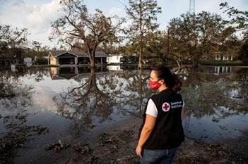 American Red Cross worker looking out on flooding caused by Hurricane Ida outside of Vacherie, Louisiana on Sept. 3, 2021