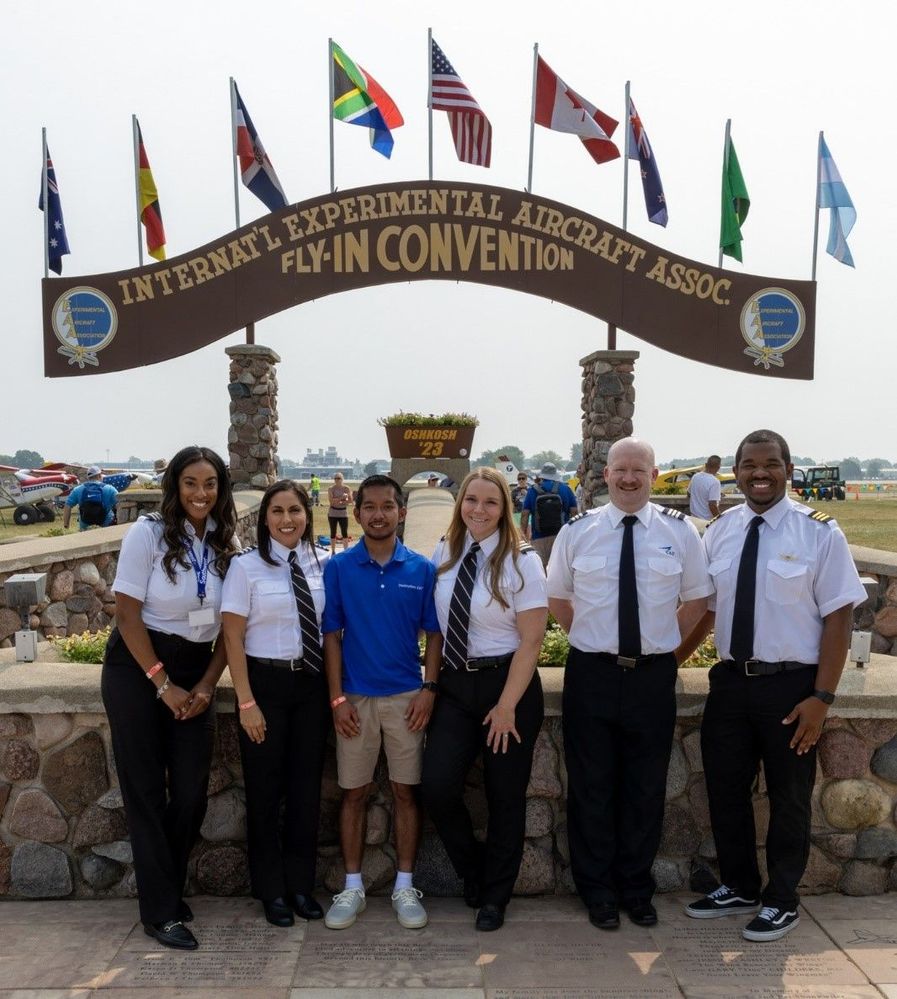 Destination 225° program participants and Southwest Airlines First Officers smile in front of the Historic Brown Arch at EAA AirVenture.jpg