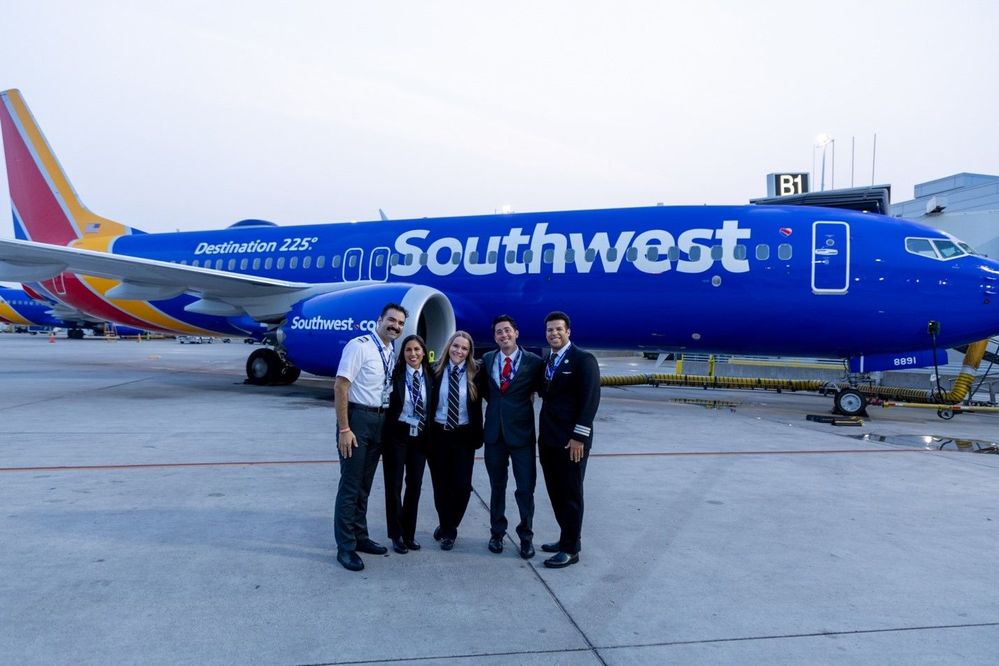 Photo of five pilots smiling in front of Southwest Airline's Destination 225° commemorative aircraft.jpg