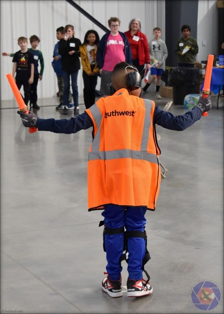 A student participating in the ramp agent station, donning Southwest safety gear. Photo by Paul Gordon.