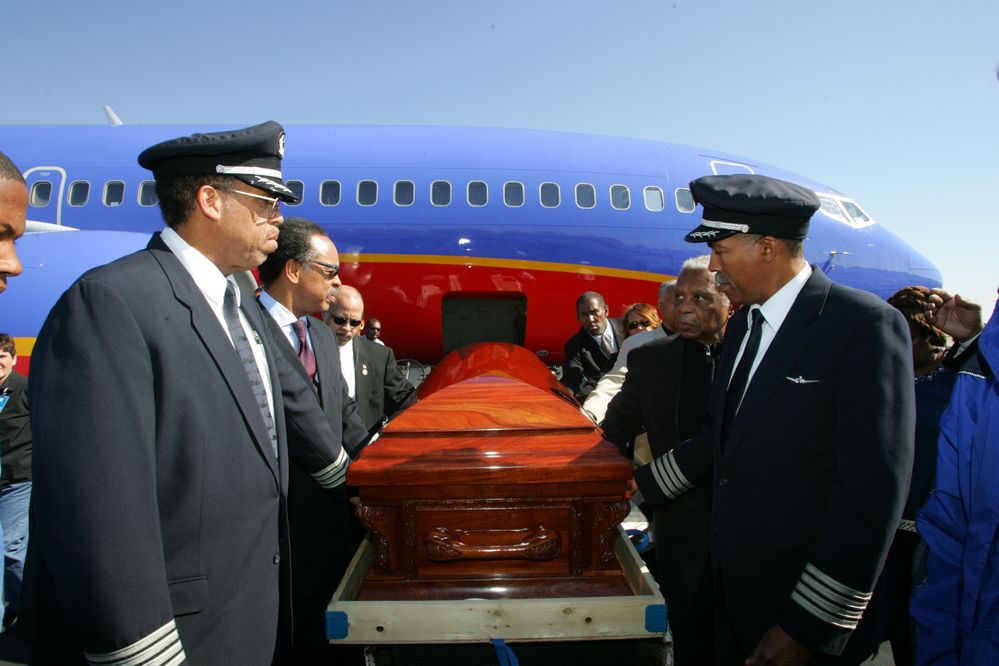 Captain Lou Freeman, left, and Captain Richard Turner with the casket of Rosa Parks.